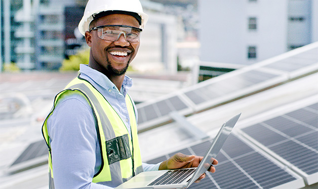 Renewable energy technician with laptop computer.